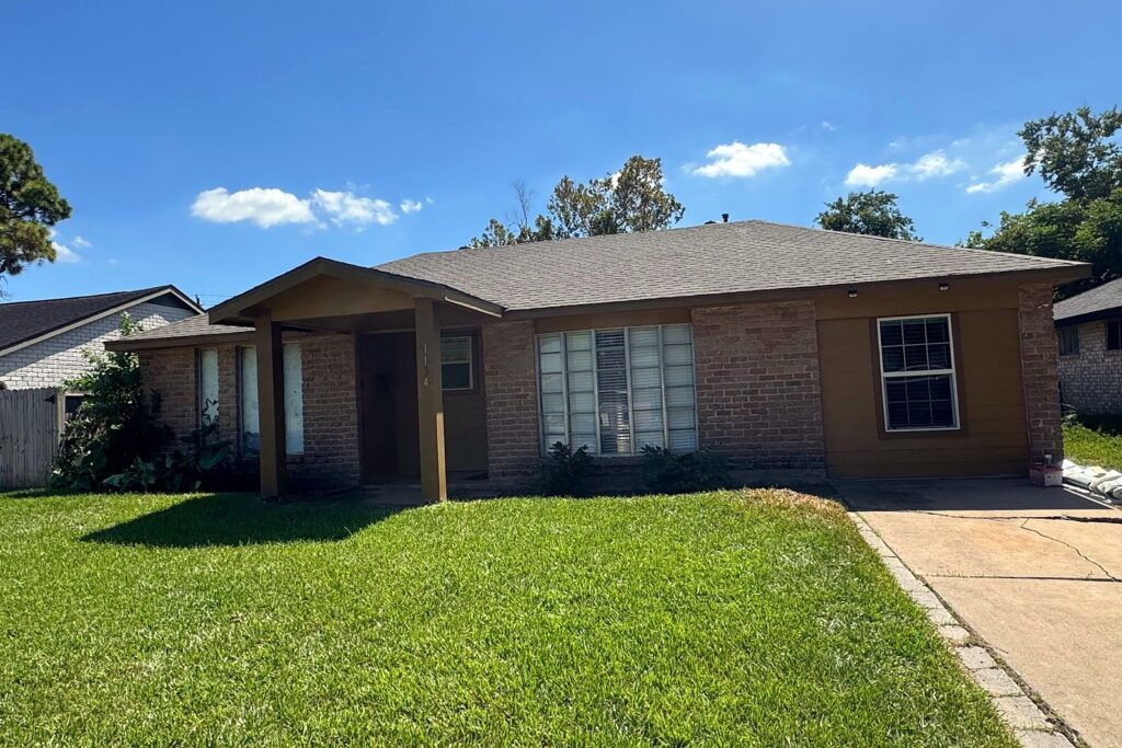 Completed roof replacement on a single-story brick home in Houston, TX