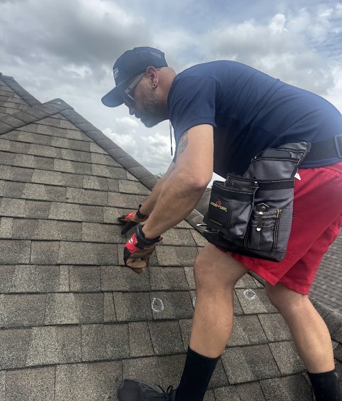 Texas Storm Pro technician inspecting shingles during a free roof inspection