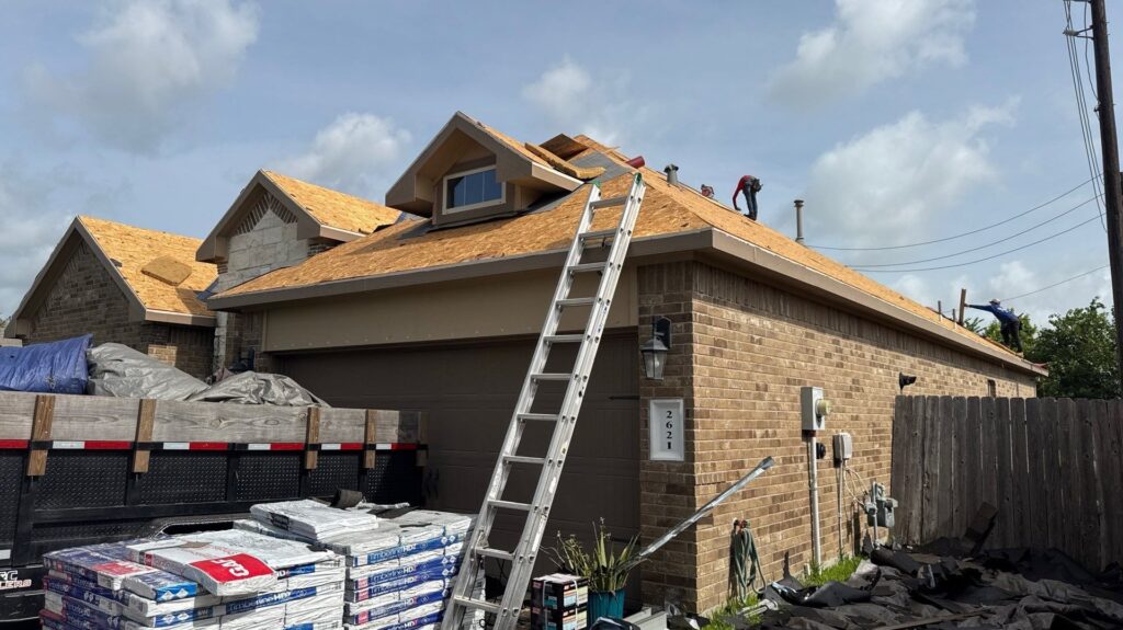 Storm-damaged Texas home mid roof replacement with a ladder and shingle pallets on site