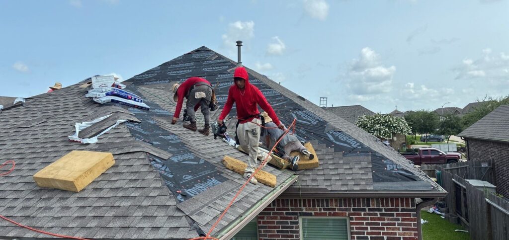 Texas Storm Pro roofing crew installing new shingles on a residential roof